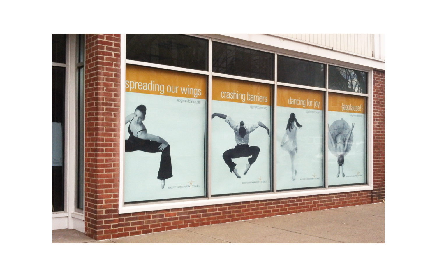 Life-size dance imagery fills enormous window banners that convey unique branding while transforming view at this performing arts school